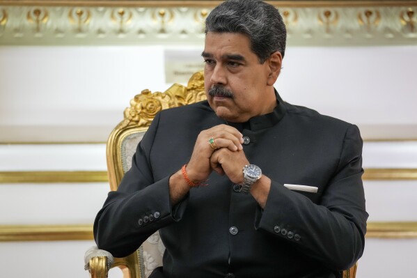 FILE - Venezuelan President Nicol谩s Maduro listens during their meeting at Miraflores presidential palace in Caracas, Venezuela, Feb. 20, 2024. On Thursday, Feb. 22, Joshua Holt, a Utah man imprisoned for nearly two years in Venezuela, sued Maduro, accusing the leftist leader of heading a 鈥渃riminal enterprise鈥� that kidnaps, tortures and unjustly imprisons American citizens. (AP Photo/Ariana Cubillos, File)