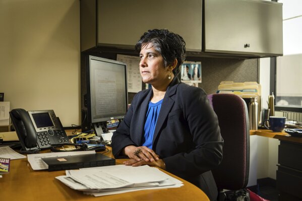 
              In this April 16, 2019 photo, Dr. Hina Shah poses at Golden Gate University in San Francisco, where she is a professor and the director of the Women's Employment Rights Clinic, which represents low-wage workers on issues of wage theft, discrimination and harassment. Residential senior care homes are treating workers as indentured servants – and profiting handsomely. The profit margins can be huge and, for violators of labor laws, hinge on the widespread exploitation of thousands of caretakers, many of them poor immigrants effectively earning $2 to $3.50 an hour to work around the clock. "Many of the cases that are being brought by workers are challenging flat-rate pay for 24 hours of work, conditions that are akin to modern-day slavery," she said. (James Tensuan/Reveal via AP)
            