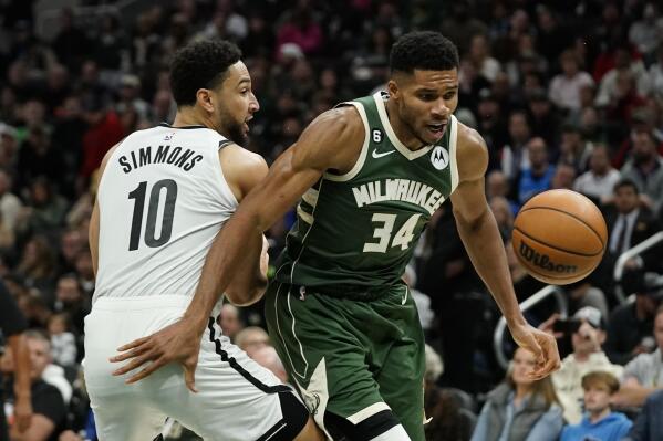 Milwaukee Bucks' Giannis Antetokounmpo (34) and Brooklyn Nets' Ben Simmons (10) go after the ball during the second half of an NBA basketball game Wednesday, Oct. 26, 2022, in Milwaukee. The Bucks won 110-99. (AP Photo/Morry Gash)