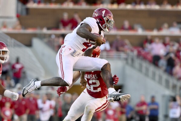 FILE - Alabama quarterback Jalen Milroe (4) tries to get past Arkansas linebacker Drew Sanders (42) during the second half of an NCAA college football game Saturday, Oct. 1, 2022, in Fayetteville, Ark. Alabama opens their season at home against Middle Tennessee on Sept. 2. (AP Photo/Michael Woods, File)