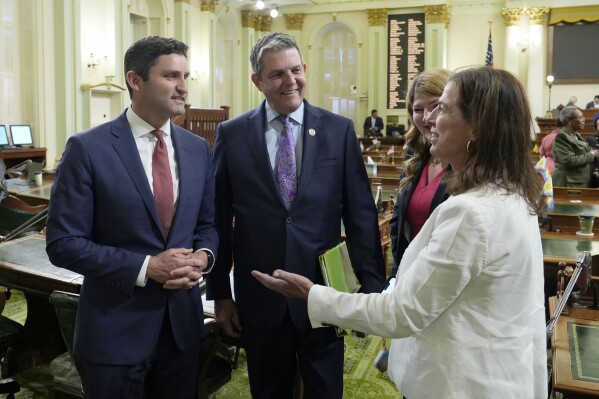 Democratic Assemblymember Jesse Gabriel, left, chairman of the Assembly Budget Committee, receives congratulations from fellow Assembly Democrats, Jim Wood, second from left, Trisha Boerner, third from left, and Diane Papan, right, after the Assembly approved the budget trailer bills at the Assembly in Sacramento, Calif. Wednesday, June 26, 2024. (AP Photo/Rich Pedroncelli)