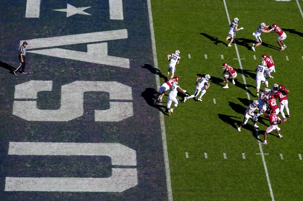 Navy quarterback Blake Horvath, center, runs with the ball on his way to a 95-yard touchdown run during the second half of the Armed Forces Bowl NCAA college football game against Oklahoma, Friday, Dec. 27, 2024, in Fort Worth, Texas. Navy won 21-20. (AP Photo/Julio Cortez)