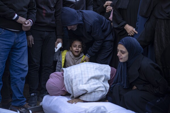 Palestinians mourn their relatives killed in the Israeli bombardment of the Gaza Strip, in the hospital in Khan Younis, Tuesday, Nov. 21, 2023. (AP Photo/Fatima Shbair)