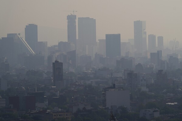 Smog hovers in Mexico City, early Wednesday, May 22, 2024. (AP Photo/Marco Ugarte)