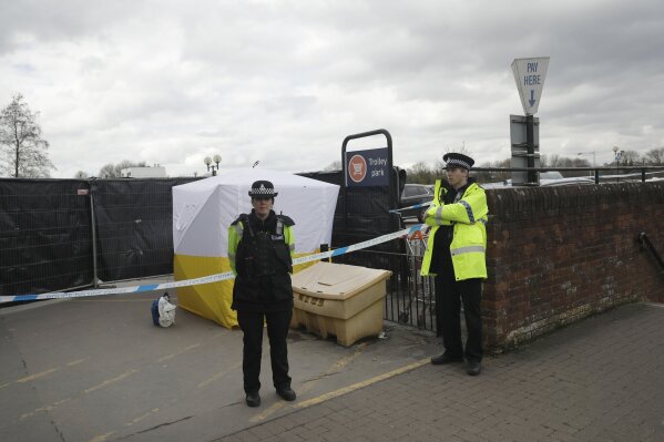 
              FILE - In this March 13, 2018, file photo, police officers guard a cordon around a police tent covering a supermarket car park pay machine near the spot where former Russian spy Sergei Skripal and his daughter were found critically ill following exposure to the Russian-developed nerve agent Novichok in Salisbury, England. The United States will impose sanctions on Russia for the country’s use of a nerve agent in an assassination attempt on a former Russian spy and his daughter. The State Department says Aug. 8, sanctions will be imposed on Russia as the country used chemical or biological weapons in violation of international law.(AP Photo/Matt Dunham, File)
            