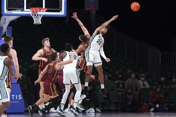 In a photo provided by Bahamas Visual Services, Michigan State forward Malik Hall (25) vies for the ball against Loyola-Chicago during an NCAA college basketball game at Paradise Island, Bahamas, Wednesday, Nov. 24, 2021. (Tim Aylen/Bahamas Visual Services via AP)