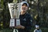 Lydia Ko holds the trophy after winning the Hilton Grand Vacations Tournament of Champions LPGA golf tournament in Orlando, Fla., Sunday, Jan. 21, 2024. (AP Photo/Kevin Kolczynski)