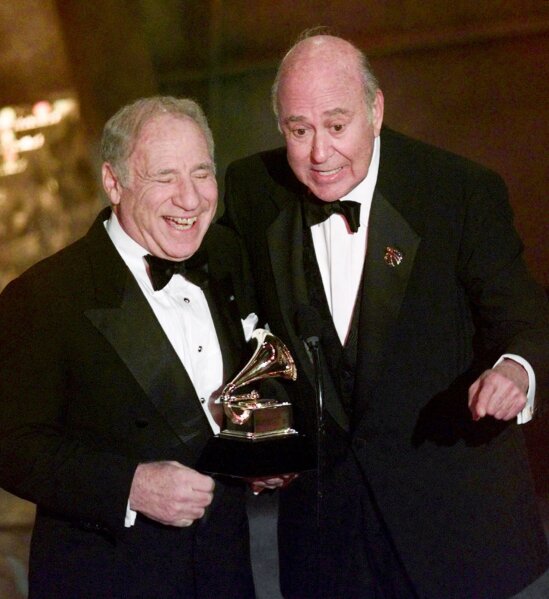 FILE - In this Feb. 24, 1999 file photo, Mel Brooks, left, and Carl Reiner accept their award for best spoken comedy album, "The 2000 Year Old Man in the Year 2000," during the 41st Annual Grammy Awards in Los Angeles. Reiner, the ingenious and versatile writer, actor and director who broke through as a “second banana” to Sid Caesar and rose to comedy’s front ranks as creator of “The Dick Van Dyke Show” and straight man to Mel Brooks’ “2000 Year Old Man,” has died, according to reports. Variety reported he died of natural causes on Monday night, June 29, 2020, at his home in Beverly Hills, Calif. He was 98. (AP Photo/Kevork Djansezian, File)