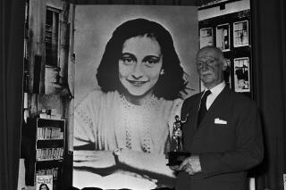 FILE - Dr. Otto Frank holds the Golden Pan award, given for the sale of one million copies of the famous paperback, "The Diary of Anne Frank". A high school along Florida’s Atlantic Coast has removed a graphic novel based on the diary of Anne Frank after a leader of a conservative group challenged it, claiming it minimized the Holocaust. “Anne Frank’s Diary: The Graphic Adaptation” was removed from a library at Vero Beach High School after a leader of Moms for Liberty in Indian River County raised an objection. (AP Photo/Dave Caulkin, file)