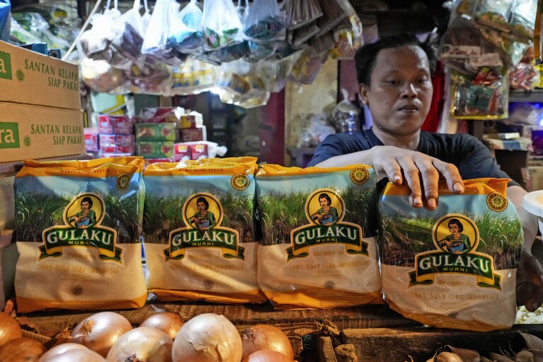 A vendor arrange packages of sugar at a market in Jakarta, Indonesia on Tuesday, Oct. 24, 2023. Indonesia 鈥� the biggest sugar importer last year, according to the United States Department of Agriculture 鈥� has cut back on imports. (AP Photo/Tatan Syuflana)