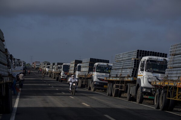 FILE - Trucks carry aluminum alloy frames to Adani Green Energy Limited's Renewable Energy Park near Khavda, Bhuj district near the India-Pakistan border in the western state of Gujarat, India, Sept. 21, 2023. (AP Photo/Rafiq Maqbool, File)