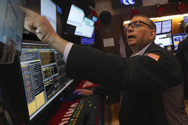 Trader Jonathan Mueller works on the floor of the New York Stock Exchange, Tuesday, March 11, 2025. (AP Photo/Richard Drew)