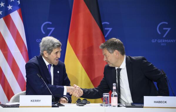 German Economy and Climate Minister Robert Habeck, right, and John Kerry, left, Special Envoy of the U.S. President for Climate, shake hands after they signed a declaration of intent to establish a German-American climate and energy partnership between the United States of America and Germany at the meeting of the G7 Ministers for Climate, Energy and Environment in Berlin, Germany, Monday, May. 27, 2022. (Bernd von Jutrczenka/dpa/dpa via AP)