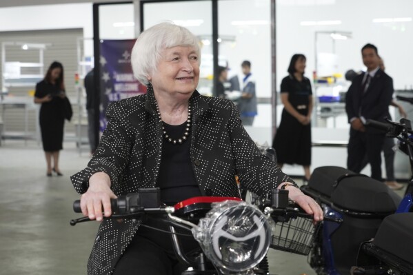 U.S. Treasury Secretary Janet Yellen sits on a scooter while visiting a factory assembling electric scooters in Hanoi, Vietnam on Thursday, July 20, 2023. The U.S. considers building strong economic and security ties with Vietnam a priority, Yellen said as she met with Vietnamese officials in a visit aimed at fortifying America's relations across Asia. (AP Photo/Hau Dinh)