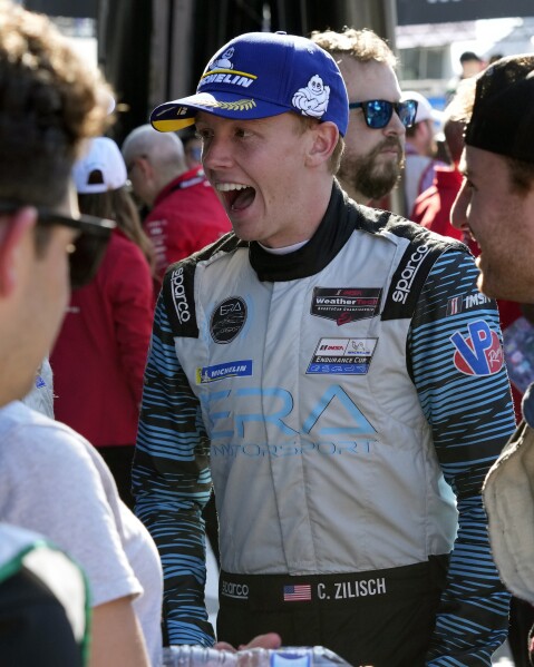 Connor Zilisch greets team members after the Rolex 24 hour auto race at Daytona International Speedway, Sunday, Jan. 28, 2024, in Daytona Beach, Fla. Connor Zilisch is coming off back-to-back sports car class victories at Daytona and Sebring and the teen sensation now turns his attention to NASCAR. (AP Photo/John Raoux)