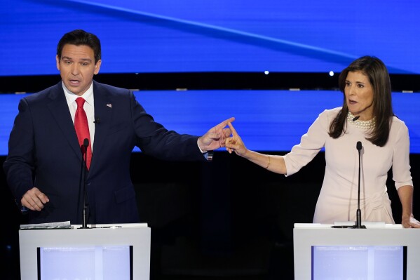 Former UN Ambassador Nikki Haley, right and Florida Gov. Ron DeSantis, left, pointing at each other during the CNN Republican presidential debate at Drake University in Des Moines, Iowa, Wednesday, Jan. 10, 2024. (AP Photo/Andrew Harnik)