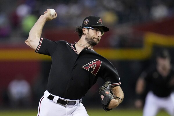 Arizona Diamondbacks starting pitcher Zac Gallen throws to a Texas Rangers batter during the first inning of a baseball game Tuesday, Aug. 22, 2023, in Phoenix. (AP Photo/Ross D. Franklin)