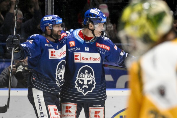 Kladno players Antonin Melka, left, and Jaromir Jagr celebrate their first goal during the hockey game between Rytíři Kladno and VHK Robe Vsetín in Kladno, Czech Republic, Thursday, April 18, 2024. Jaromir Jagr returned to action on Thursday for the first time since turning 52 and immediately scored as he beat legend Gordie Howe to become the oldest player in a professional competition. (Ondrej Deml/CTK via AP) SLOVAKIA OUT
