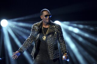 FILE - In this June 30, 2013 file photo, R. Kelly performs at the BET Awards at the Nokia Theatre in Los Angeles. R. Kelly is announcing a new tour, but it won't be in the United States. The embattled entertainer announced on social media Tuesday, Feb. 5, 2019, that he'll be going to Australia, New Zealand and Sri Lanka. (Photo by Frank Micelotta/Invision/AP, File)
