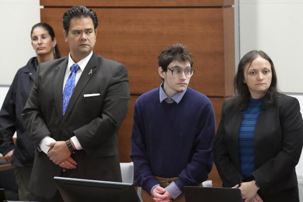 Marjory Stoneman Douglas High School shooter Nikolas Cruz stands with his attorneys, Chief Assistant Public Defender David Wheeler and sentence mitigation specialist Kate O'Shea as prospective jurors enter the courtroom for jury pre-selection in the penalty phase of the trial at the Broward County Courthouse in Fort Lauderdale on Monday, May 2, 2022. Cruz previously plead guilty to all 17 counts of premeditated murder and 17 counts of attempted murder in the 2018 shootings. (Amy Beth Bennett/South Florida Sun Sentinel via AP, Pool)