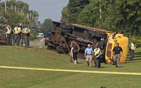 Authorities work on the scene of a bus crash in Lawrenceville, Ohio, Tuesday, Aug. 22, 2023. (Bill Lackey/The Springfield News-Sun via AP)