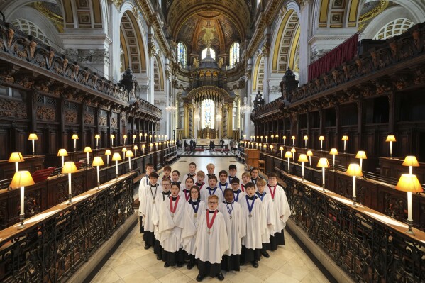 The Choristers of St Paul's choir, including girls for first time in 900-year history, rehearse for the Christmas services in St Paul's Cathedral, in London, Monday, Dec. 23 2024. (AP Photo/Kin Cheung)