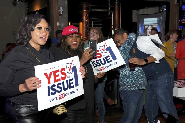 Hamilton County Commissioner Alicia Reece, second from left, joins voters in response to the passage of Ohio Issue 1, a ballot measure to amend the state constitution and establish the right to abortion, at an election night event hosted by the Hamilton County Democratic Party, Tuesday, Nov.  7, 2023, at Knox Joseph Distillery in Cincinnati's Over-the-Rhine neighborhood.  (Kareem Elgazzar/The Cincinnati Enquirer via AP)
