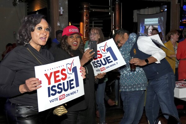 Hamilton County Commissioner Alicia Reece, second from left, joins voters in reacting to the passage of Ohio Question 1, a ballot measure to amend the state constitution and to establish the right to abortion, during an election night event hosted by the Hamilton County Democratic Party, Tuesday, November 7, 2023, at the Knox Joseph Distillery in Cincinnati's Over-the-Rhine neighborhood.  (Kareem Elgazzar/The Cincinnati Enquirer via AP)