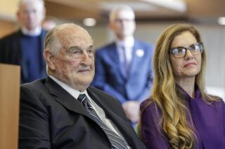 FILE - Philanthropist Walter Scott, left, sits next to Leslie Jackson, wife of glass artist Dale Chihuly during a ceremony at the Fred & Pamela Buffett Cancer Center in Omaha, Neb., Friday, May 19, 2017. Billionaire Scott, the past top executive of Peter Kiewit Sons Inc. construction firm who helped oversee Warren Buffett’s conglomerate and donated to various causes, particularly construction projects around Omaha, died, Saturday, Sept. 25, 2021. He was 90. (AP Photo/Nati Harnik, File)