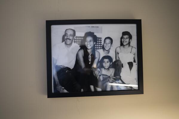 A photograph of Alex Morisey, third left, and his family hangs on the wall in his room at a nursing home in Philadelphia, on Wednesday, Feb. 15, 2023. Living simply is at the heart of Morisey’s Quaker faith and he decided after college, Ivy League diploma in hand, that he wouldn’t use it to chase wealth. He took jobs in nonprofits, putting his skills to the aid of farmworkers, public housing tenants and the mentally ill, and as an aid worker in Central and South America. (AP Photo/Wong Maye-E)