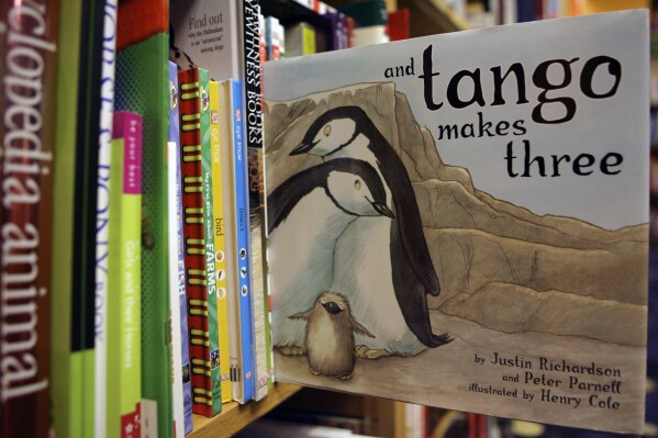 FILE - A copy of the book "And Tango Makes Three" is photographed on a bookstore shelf in Chicago, Nov. 16, 2006. Months after access to the popular children's book about a male penguin couple hatching a chick was restricted at school libraries because of Florida's so-called “Don't Say Gay” law, a central Florida school district says it has reversed that decision. The complaint challenged the restrictions and Florida's new law prohibiting classroom discussion about sexual orientation or gender identity in certain grade levels. (AP Photo/Nam Y. Huh, File)