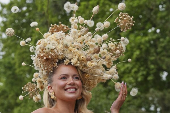 Model and dancer Tasha Ghouri poses as she wears a head piece for The King's Trust garden designed by Joe Perkins at the RHS Chelsea Flower Show in London, Monday, May 19, 2025. (AP Photo/Kirsty Wigglesworth)