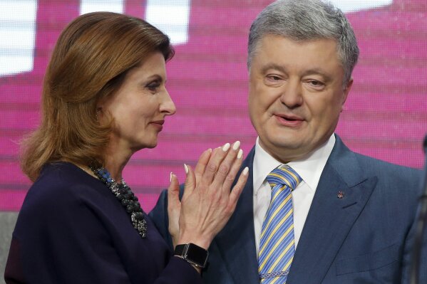 
              Ukrainian President Petro Poroshenko's wife Maryna stands with her husband at his headquarters after the second round of presidential elections in Kiev, Ukraine, Sunday, April 21, 2019. Ukrainian President Petro Poroshenko is accepting defeat in the election for the country's top post. (AP Photo/Efrem Lukatsky)
            