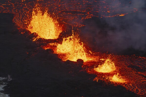 A close up of the Southern active segment of the original fissure of an active volcano in Grindavik on Iceland's Reykjanes Peninsula, Tuesday, Dec. 19, 2023. (AP Photo/Marco Di Marco)