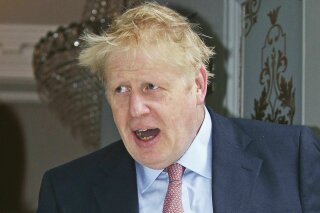 Conservative party leadership contender Boris Johnson leaves his home in London, Monday June 17, 2019. Candidates seeking to beat Boris Johnson and become Britain's next prime minister accused the Brexit-backing front runner of trying to avoid scrutiny after he refused to take part in a televised debate alongside his five rivals Sunday. (Jonathan Brady/PA via AP)