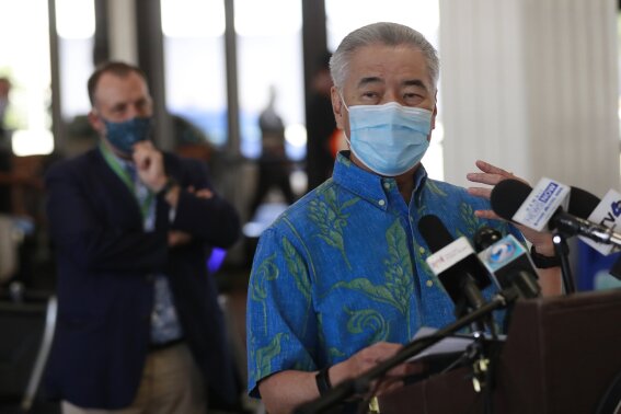 FILE - In this Oct. 15, 2020, file photo, Hawaii Gov. David Ige speaks at a news conference at the Daniel K. Inouye International Airport in Honolulu. A year after the first coronavirus shutdowns, many U.S. states and cities are still struggling with a silent side effect: Public records have become harder to get. Ige, a Democrat, took the most sweeping action when he suspended the state’s entire open-records law in March 2020. Ige eased the suspension under pressure from open-government advocates. (AP Photo/Marco Garcia, File)