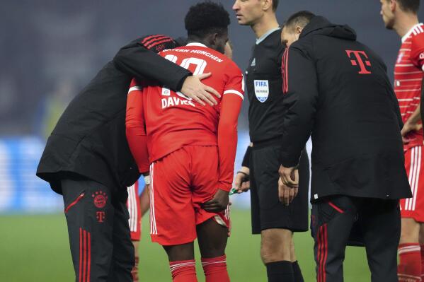 Bayern's Alphonso Davies holds his upper leg while he leaves the pitch during the German Bundesliga soccer match between Hertha BSC Berlin and FC Bayern Munich in Berlin, Germany, Saturday, Nov. 5, 2022. (AP Photo/Michael Sohn)