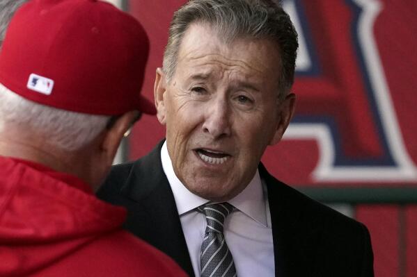 FILE - Los Angeles Angels owner Arte Moreno, right, talks with Angels manager Joe Maddon prior to a baseball game against the Cleveland Guardians, April 26, 2022, in Anaheim, Calif. Moreno has decided not to sell his team. He took his franchise off the market Monday, Jan. 23, 2023, after announcing his plan to explore a sale of the team last August. The 76-year-old owner met with prospective buyers during the winter. (AP Photo/Mark J. Terrill, File)
