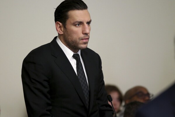 FILE - Boston Bruins forward Milan Lucic stands during his arraignment Tuesday, Nov. 21, 2023, in Boston Municipal Court, in Boston, on an assault charge in connection with his arrest over the weekend after his wife called police to their home and said he tried to choke her. Prosecutors dropped a domestic violence charge against Boston Bruins forward Milan Lucic on Friday, Feb. 16, 2024, saying the decision by his wife to invoke marital privilege made it impossible for them to prove their case beyond a reasonable doubt.(Jonathan Wiggs/The Boston Globe via AP, Pool, File)