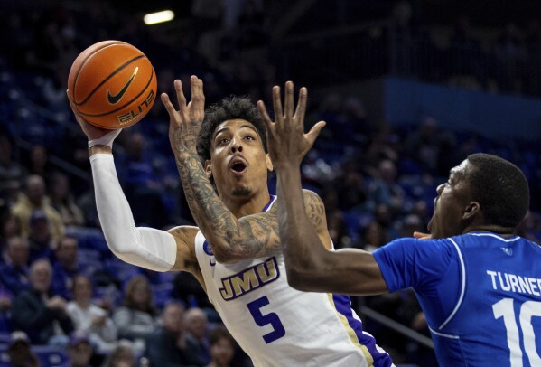 FILE - James Madison guard Terrence Edwards Jr. (5) shoots against Georgia State forward Jay'Den Turner (10) during the first half of an NCAA college basketball game in Harrisonburg, Va., Thursday, Feb. 15, 2024. James Madison’s Terrence Edwards says his team has been dealing with pressure ever since it stunned the college basketball world with a season-opening upset of then-No. 4 Michigan State. Edwards and the Dukes are hoping it enables them to make a similar impact on March Madness.(Daniel Lin/Daily News-Record via AP, File, File)