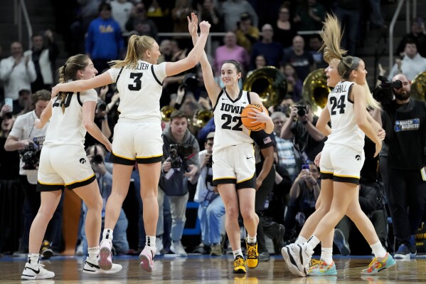 Iowa guard Caitlin Clark (22) celebrates with teammates after defeating LSU in an Elite Eight round college basketball game during the NCAA Tournament, Monday, April 1, 2024, in Albany, N.Y. (AP Photo/Mary Altaffer)