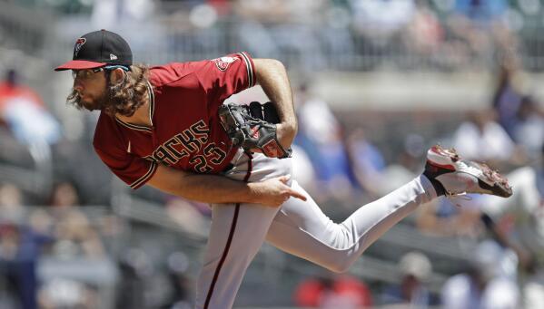 Bumgarner pitches Giants to win and swings the bat, too