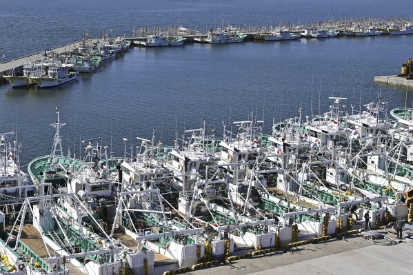 Fishing boats line up at a port in Soma, Fukushima prefecture, Japan Tuesday, Aug. 22, 2023. Japan will start releasing treated and diluted radioactive wastewater from the Fukushima Daiichi nuclear plant into the Pacific Ocean as early as Thursday, a controversial but essential early step in the decades of work to shut down the facility 12 years after its meltdown disaster. (Kyodo News via AP)