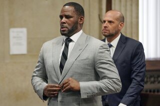FILE - In this June 6, 2019, file photo, singer R. Kelly pleaded not guilty to 11 additional sex-related felonies during a court hearing before Judge Lawrence Flood at Leighton Criminal Court Building in Chicago. R&B singer R. Kelly is due in federal court to enter a plea to an updated federal indictment that includes sex abuse allegations involving a new accuser.  The 53-year-old is expected to plead not guilty at a hearing Thursday, March 5, 2020, in Chicago to a superseding indictment unsealed last month that includes multiple counts of child pornography. (E. Jason Wambsgans/Chicago Tribune via AP, Pool, File)