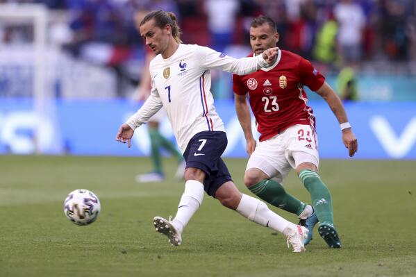 France's Antoine Griezmann gets the ball past Hungary's Nemanja Nikolic during the Euro 2020 soccer championship group F match between Hungary and France, at the Ferenc Puskas stadium, in Budapest, Saturday, June 19, 2021. (Alex Pantling, Pool via AP)
