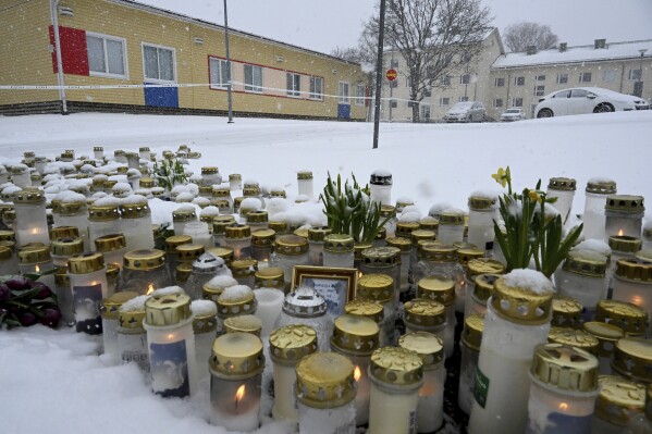 Candles, flowers and other memorabilia are placed at the Viertola school in Vantaa, Finland, Wednesday, April 3, 2024. A 12-year-old student opened fire at a secondary school in southern Finland on Tuesday morning, killing one and seriously wounded two other students, police said. The suspect was later arrested. (Jussi Nukari/Lehtikuva via AP)