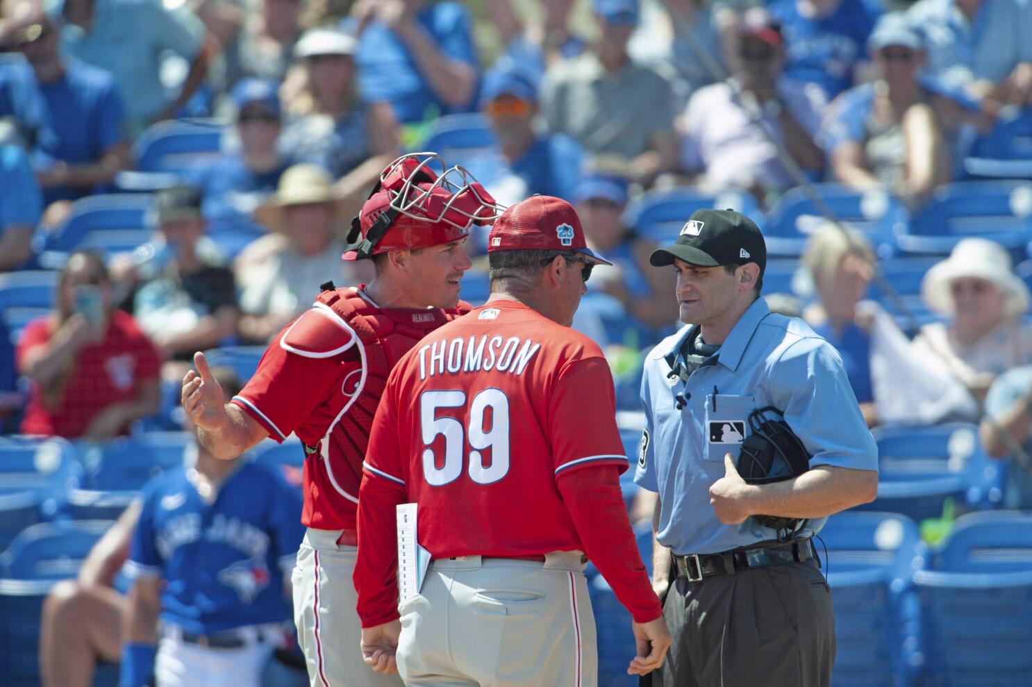 Philadelphia Phillies - J.T. Realmuto, wearing the red pinstripe uniform,  pointing to the dugout after driving in a run.