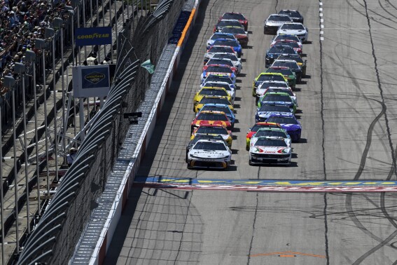 Tyler Reddick (45) leads a pack of cars to the green flag during a NASCAR Cup Series auto race at Darlington Raceway, Sunday, May 12, 2024, in Darlington, S.C. (AP Photo/Matt Kelley)