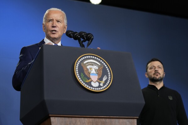 President Joe Biden, left, joined by President of Ukraine Volodymyr Zelenskyy, speaks during an event on the Ukraine Compact on the sidelines of the NATO Summit in Washington, Thursday, July 11, 2024. (AP Photo/Susan Walsh, File)