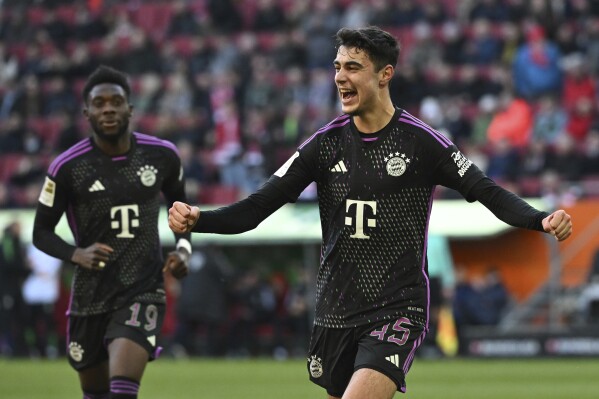 FILE - Munich's Aleksandar Pavlovic celebrates scoring during the Bundesliga soccer match between FC Augsburg and Bayern Munich at the WWK-Arena, Augsburg, Germany, on Jan. 27, 2024.Germany coach Julian Nagelsmann has called up Borussia Dortmund midfielder Emre Can to replace Pavlović, who will miss the European Championship because of illness. The German soccer federation said Wednesday June 12, 2024 that Pavlović, the young Bayern Munich midfielder who made his Germany debut in last week’s 0-0 draw with Ukraine, was unable to join the squad for the 2-1 win over Greece, Nagelsmann’s team’s final Euro 2024 warmup.(Sven Hoppe/dpa via AP, File)